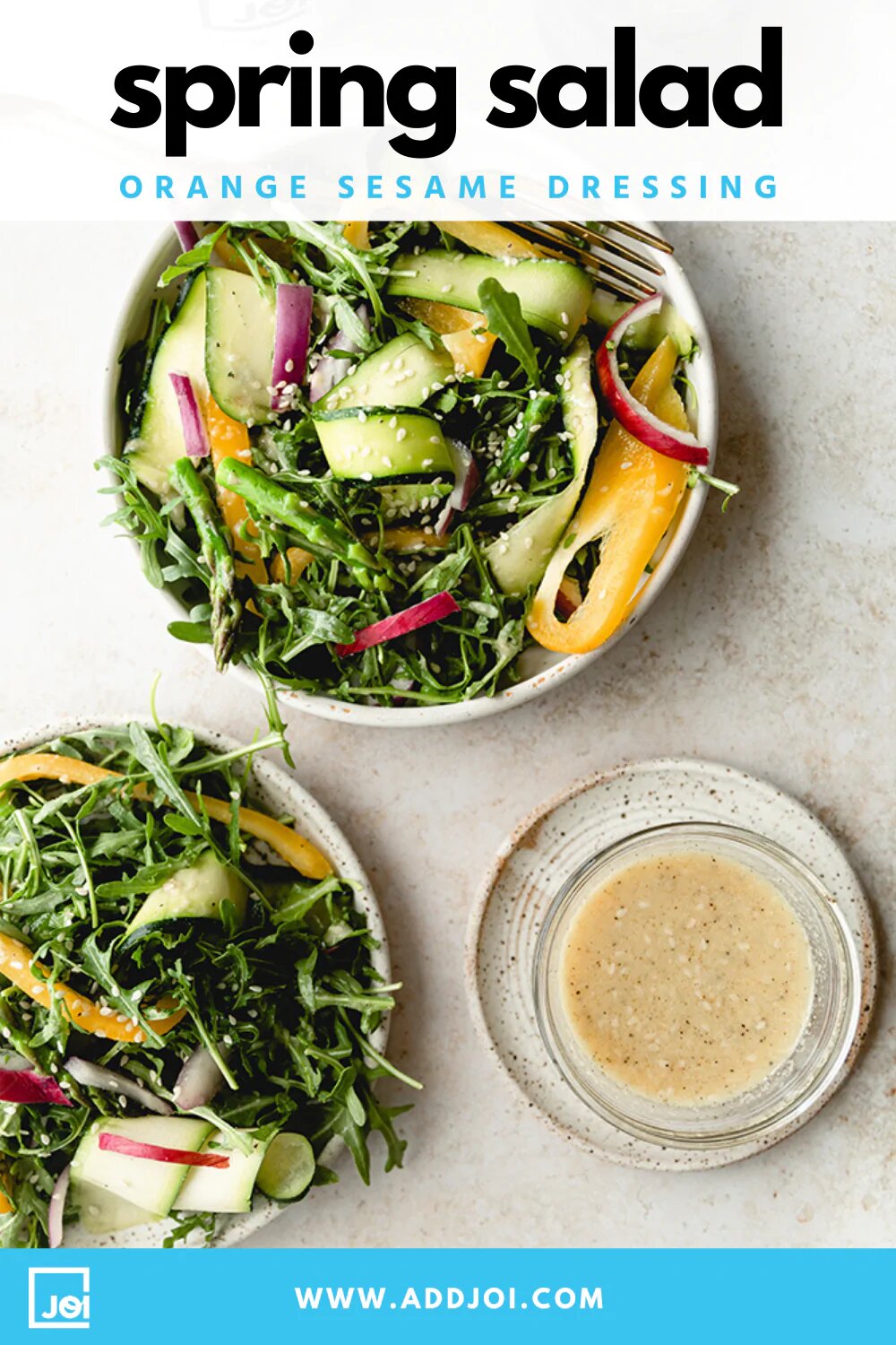 Two bowls of Spring Green Salad with orange sesame dressing, made with JOI plant bases.