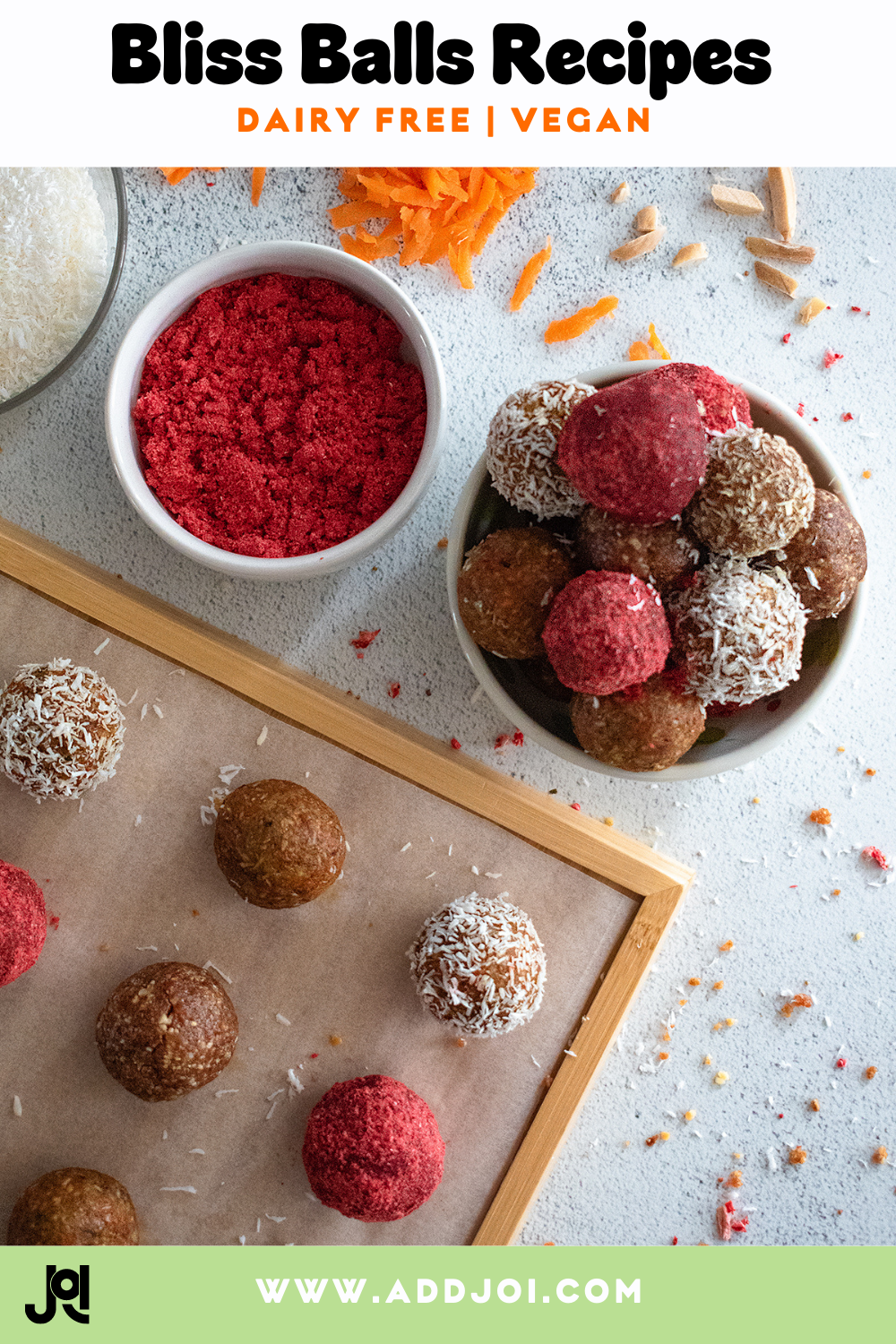 A flat lay of JOI's healthy spring bliss balls, including carrot cake and strawberry, with ingredients on a white table.