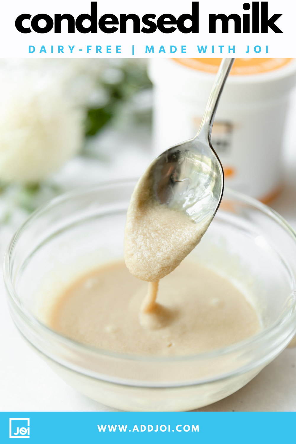 A spoon dripping dairy-free condensed milk from JOI into a glass bowl.