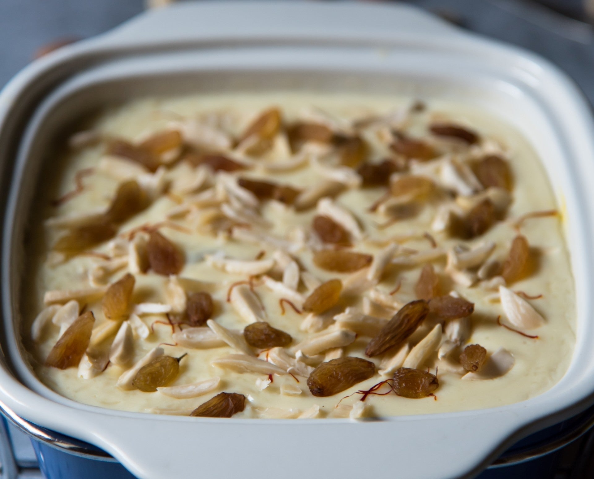 A bowl of creamy rice pudding made with JOI Almond Base, topped with almonds.