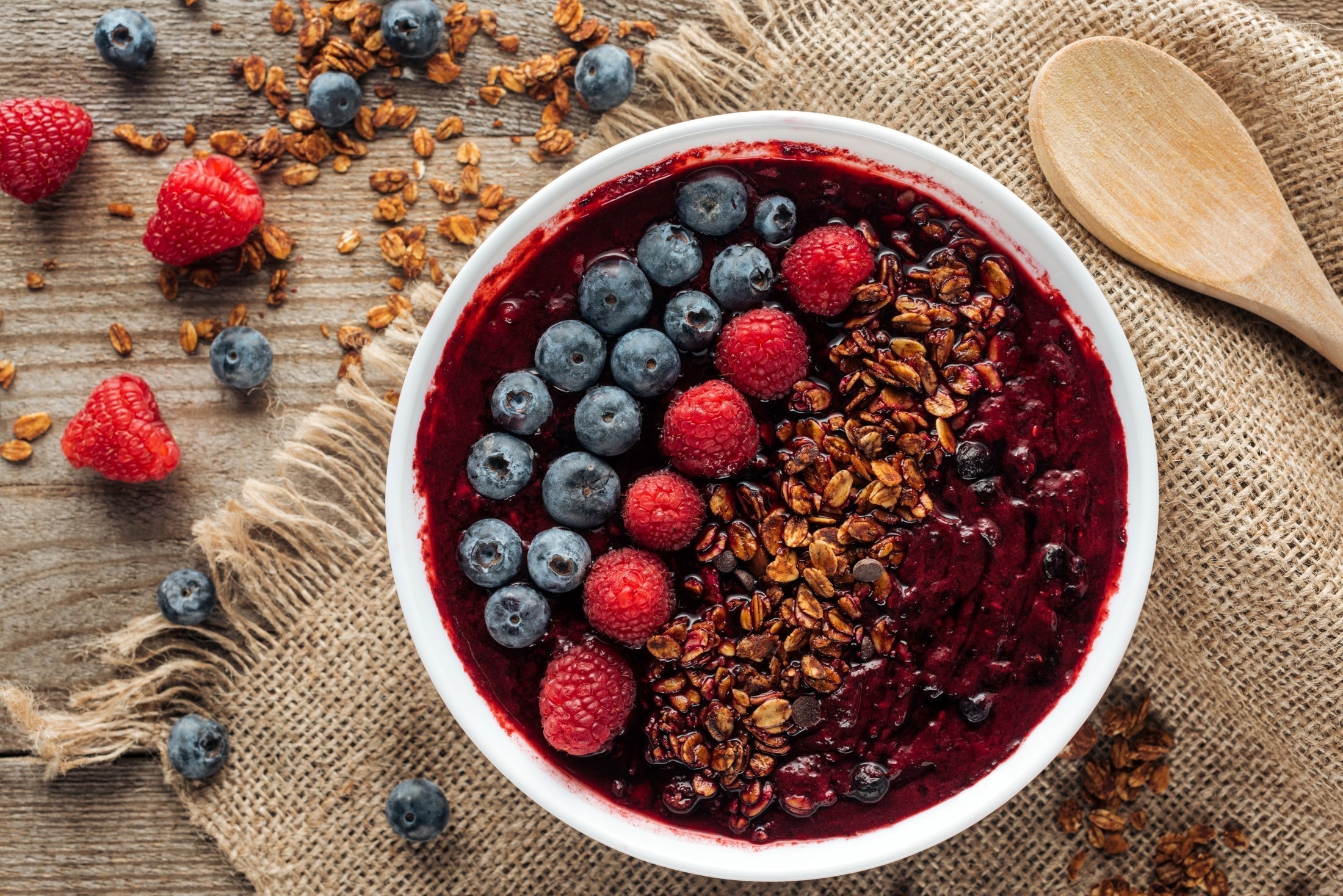 Acai bowl made with JOI Coconut Powder and thick berry base, topped with blueberries, raspberries, and granola.