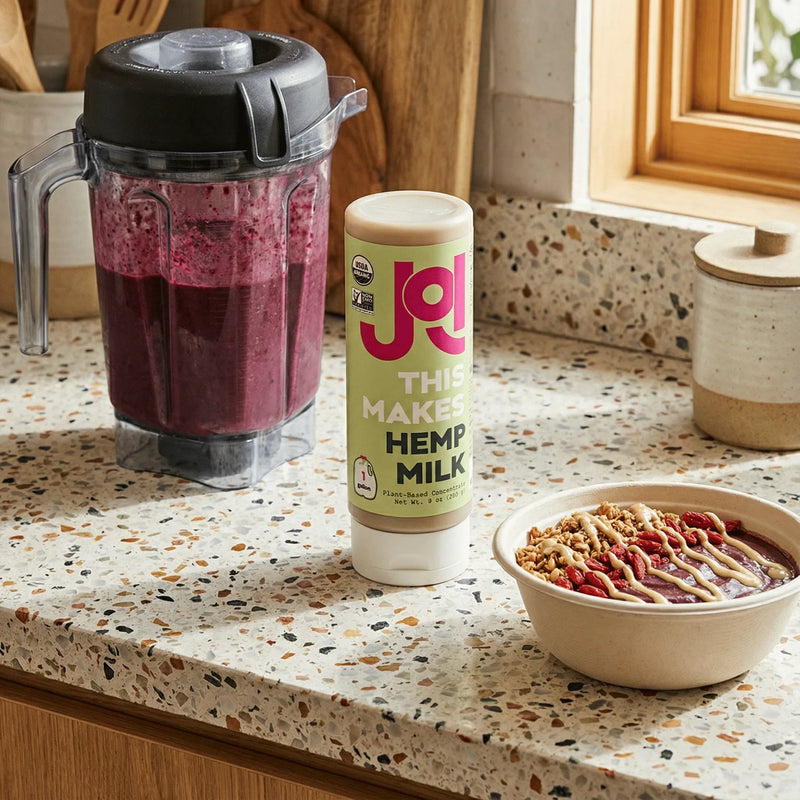 Berry smoothie, smoothie bowl, and JOI hemp milk concentrate arranged on a kitchen counter.