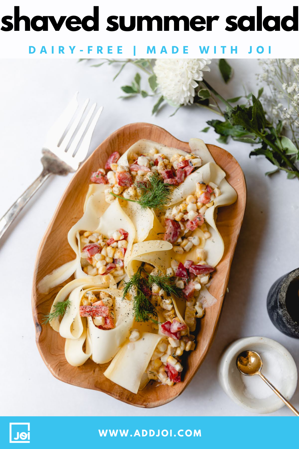 A shaved summer squash salad with corn and red peppers, garnished with dill and made with JOI plant bases.