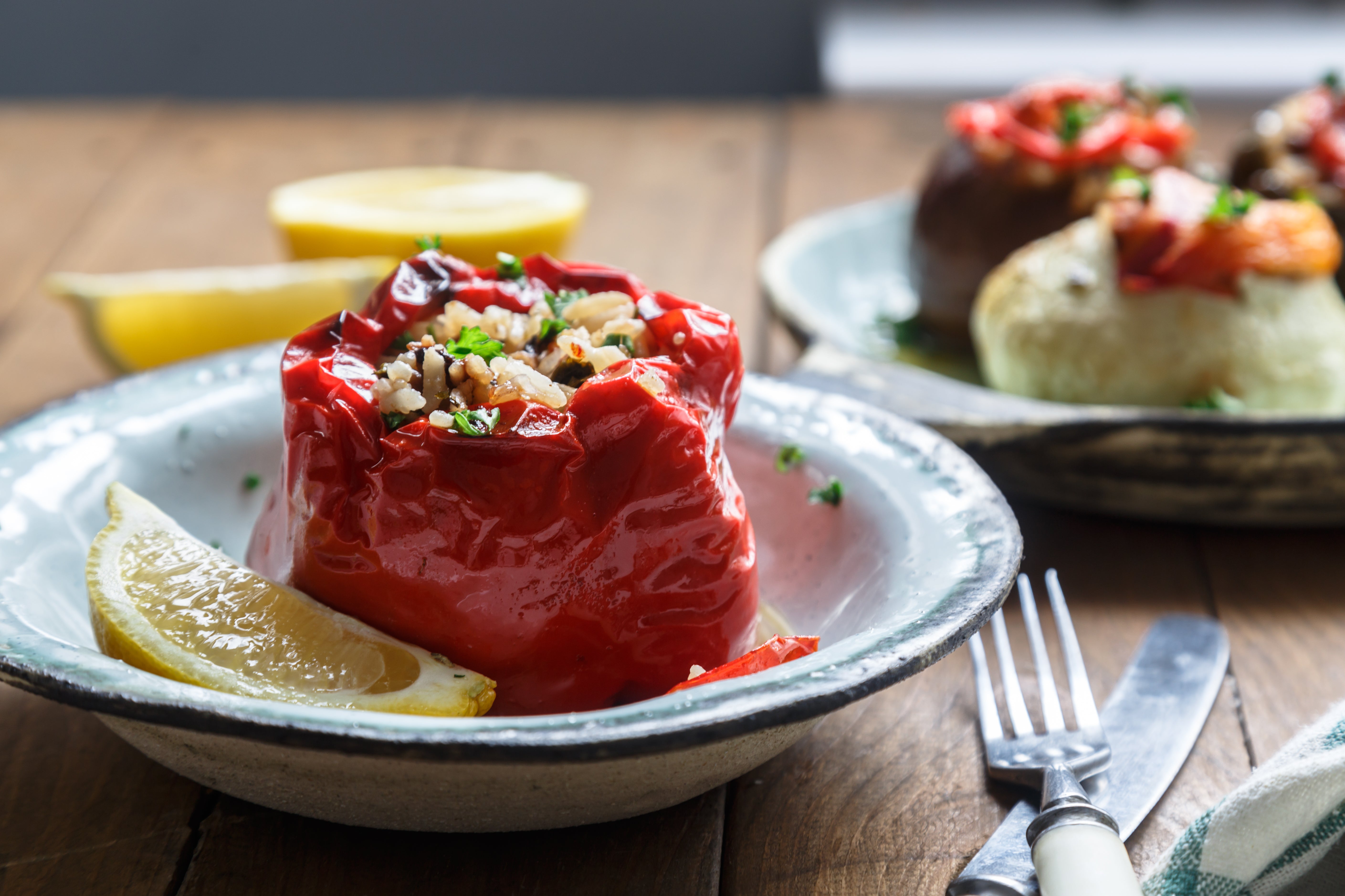 Sweet roasted bell peppers stuffed with creamy almond ricotta, herbs, and grains, served warm with a rich tomato sauce.