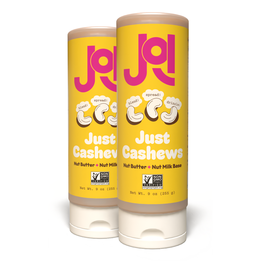 Two JOI Cashew Base plant milk concentrates in yellow cylindrical bottles with pink "JOI" branding.