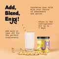 A Cashew Milk Base from JOI, shown in a glass of milk with a straw and surrounded by cashews, promotes making fresh cashew milk.