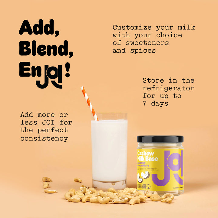 A Cashew Milk Base from JOI, shown in a glass of milk with a straw and surrounded by cashews, promotes making fresh cashew milk.