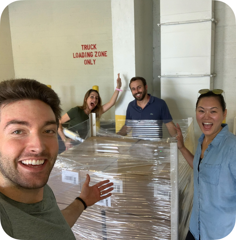 Milk These Nuts team celebrating a large product shipment at the warehouse loading dock.
