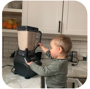 A young child having fun making JOI Milk at home in a blender