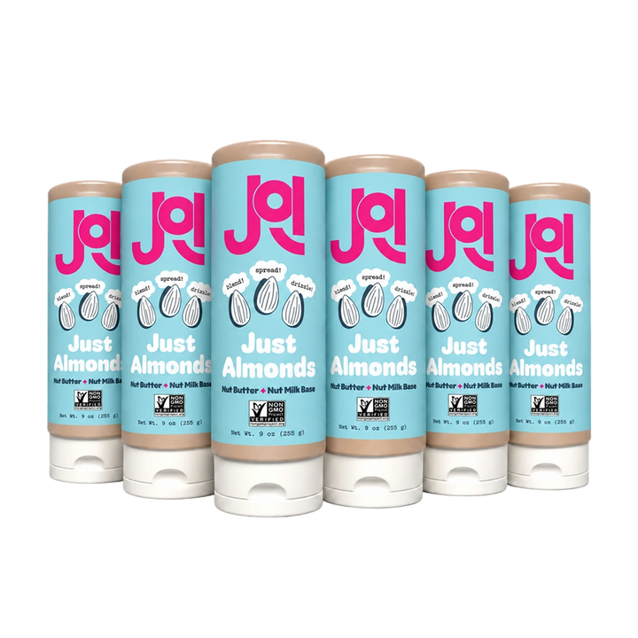 Six JOI Almond Base squeeze bottles, with blue labels featuring "Just Almonds" and "Non-GMO Project Verified" seals.